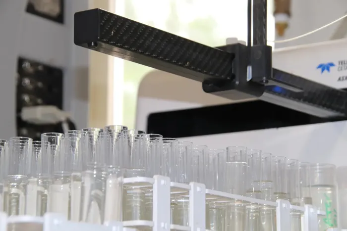 Autosampler loading plant extract samples into a lab analyzer
