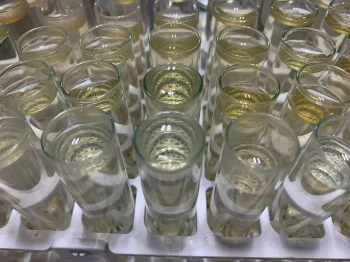 Clear liquid samples in cups at the Next Level Ag lab