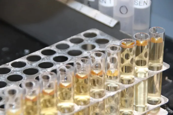 Test tubes of plant extracts in a rack at the Next Level Ag lab